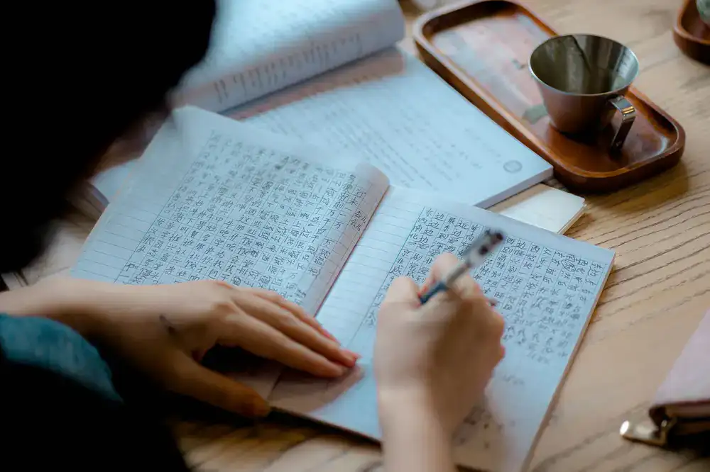 Student taking notes during a language exercise