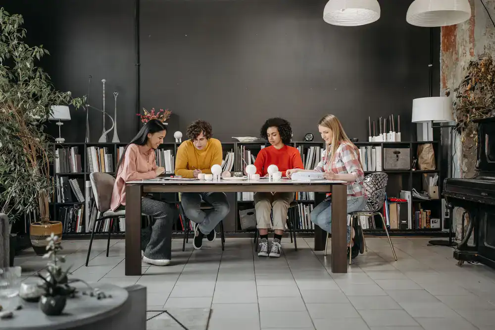A small group of adult learners at a shared table
